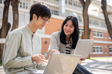 A friendly Asian female student is discussing work and helping her friend with math homework.