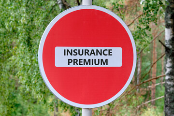 Business concept. text INSURANCE PREMIUM written on the sign entry is prohibited against the...