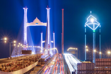 The Rama IX parallel bridge is adorned with colorful lights that create a stunning visual spectacle. It is considered to be Thailand's first double cable-stayed bridge across the Chao Phraya River.
