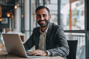 Middle aged Arab account manager working on laptop