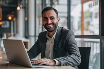 Fototapeta premium Middle aged Arab account manager working on laptop