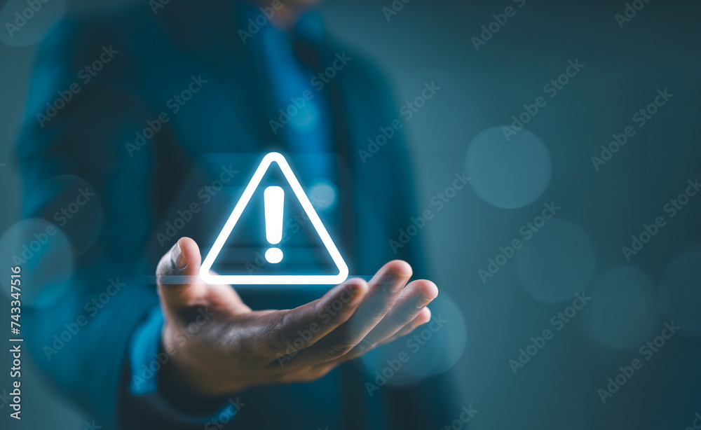 Poster businessman holding glowing of triangle caution warning exclamation sign for notification error and 