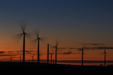 long exposure of wind turbines at sunset