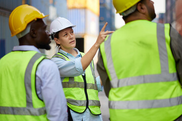 workers or engineers looking and pointing above in containers warehouse storage