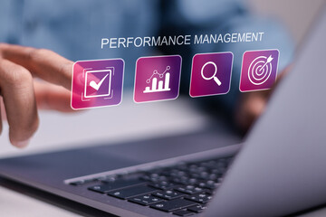 Performance Management Efficiency Improvement Business concept. Businessman use laptop with performance management icons on virtual screen.