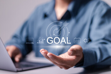 Goal concept. Achieving goals and objectives or goal setting. Businessman use laptop with goal icon on virtual screen. - obrazy, fototapety, plakaty