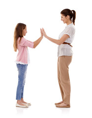 Mother, child and clapping game for bonding and fun together in studio, happy and playful on white background. Woman, young girl and hands together, playing with high five and family time for love