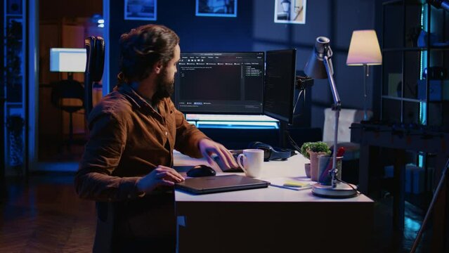 Software designer finishing remote job shift, packing backpack, leaving office after finishing coding project. IT professional putting laptop in bag, sitting up from desk chair, camera B