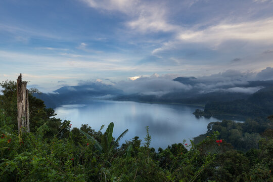 Scenic Beratan lake and forest in the hills of tropical Bali island, Tabanan Regency.