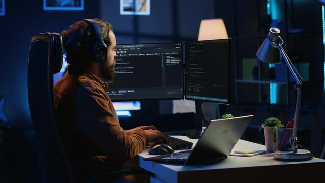 Time lapse of freelancing software developer typing complex code in RGB lit home office, developing mobile apps. Day in life of self employed computer scientist doing remote project tasks