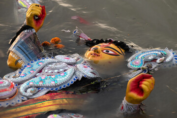 Immersion of idol goddess durga in river after completion of four days festival. Durga is created...