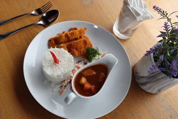 delicious japanese food dori fish katsu with curry and rice on a white plate