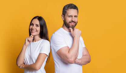 Smiling friends. Family couple. Couple of millennial man and woman isolated on yellow. Man and woman in white tshirt. Family portrait. Millennial couple with casual style. Copy space banner