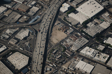 The 10 Freeway cuts through the Fashion District of Los Angeles, near the Alameda St exit. The aerial view shows the 