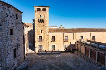 Fototapeta na wymiar Plaza with very old buildings and towers of manor houses in the city of Caceres.