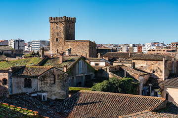 Medieval buildings rising on rooftops in an aerial view of the city of Caceres, Extremadura.