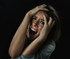 Portrait, horror and fear with woman screaming in studio on black background for reaction to...
