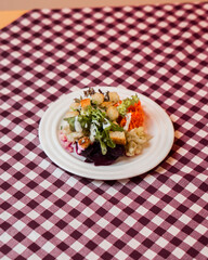 Sun-kissed mango with jewel-like water droplets rests on weathered wood, a vibrant crown atop a juicy treasure