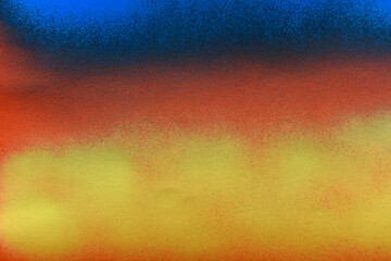 blue and yellow spray paint on orange paper background