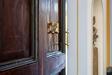 vintage golden old steel private door knocker on wooden classic gate open access