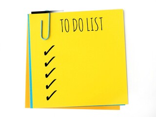 To do list with blank checklist on a yellow sticky note