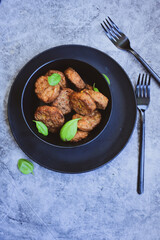 Home made  oven baked meatballs  from  chicken and vegetables and french potato  fries on  wooden background.Bifteki, or spicy meatballs 