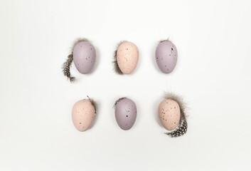 Top view of six colourful easter eggs on white background. Creative easter composition, spring, copy space, flat lay.