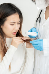 Specialist of hair recheck hair of Asian woman, damaged hair, hair loss, thinning problem, vitamin...