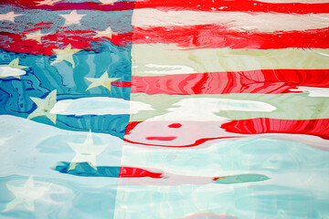 American flag reflection in water, June	