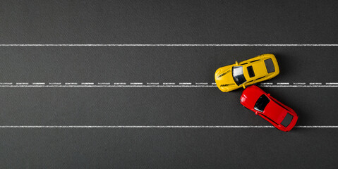 Top view of red and yellow cars colliding and crashing on dark gray background
