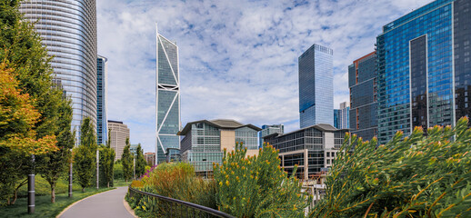 Panoramic view of a downtown skyscrapers with trees and a path in a park in the SOMA neighborhood...