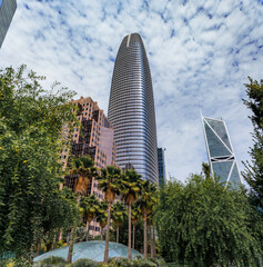 View of a downtown skyscrapers with trees in a park in the SOMA neighborhood in San Francisco,...