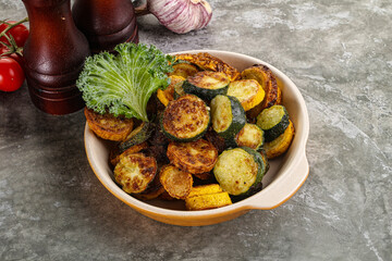 Roasted young zucchini in the plate