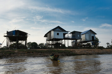Fototapeta premium A stilt wooden house in Cambodia in a dramatic background.