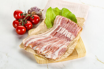 Sliced pork bacon oved board