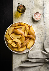 potato slices in a plate on a gray background