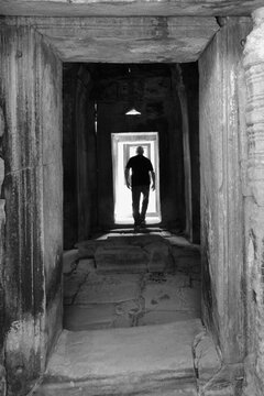 A man enters the open doors, his figure silhouetted creating this image more artistic.