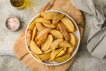 potato slices in a plate on a gray background