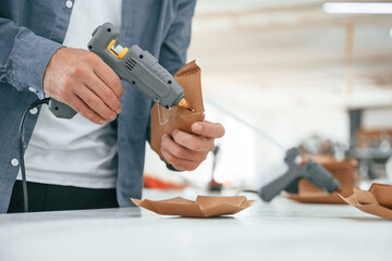 Technician is working. Handsome man is at the factory of creating eco boxes