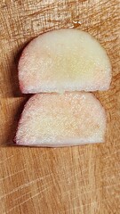 a cut peach on a cutting board
