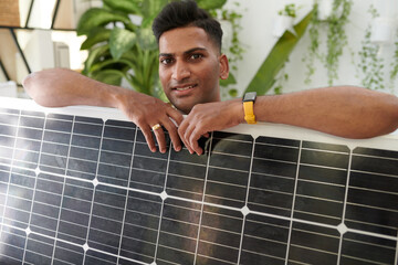 Portrait of happy customer posing with solar panel he bought