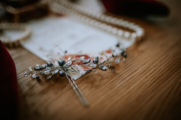 Riga, Latvia - January 20, 2024 - Close-up of a bridal tiara, pearl bracelet, and part of a wedding...
