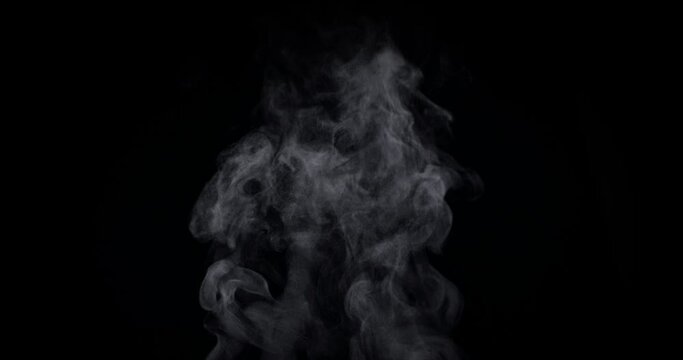 White natural rising steam from food or hot drink isolated on a black background. Сan be used in any projects with hot food. Slow motion