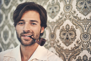Man, portrait and pipe for vintage style with antique wallpaper for retro, old school feel with gen x. Male person, smoking and decor for cool trendy look with shirt, beard and closeup with pattern