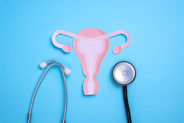 Female Uterus Cutout and Stethoscope. Ovarian cancer and Gynecological Disorders Concept.