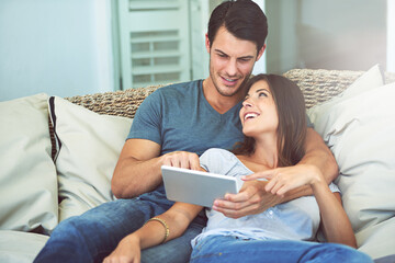 Happy couple, hug and sofa with tablet for movie, social media or entertainment at home. Man and...