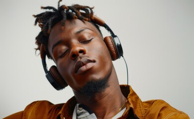 African american man dj enjoying music. Man with dreadlocks hair wearing headphones and stylish...