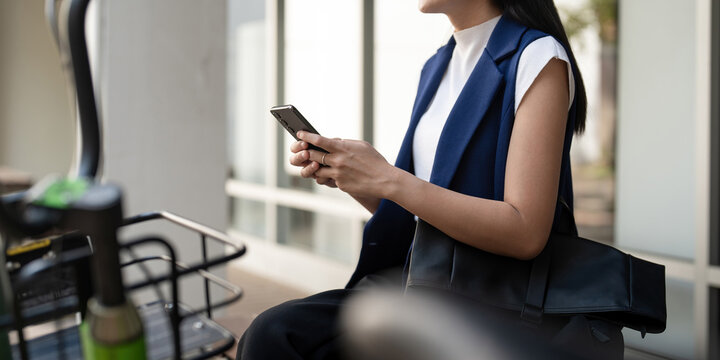 Business woman commute her bicycle bike go to work office, Asian businesswoman sit side street with bicycle and using smartphone