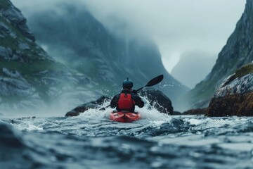 Naklejka premium A kayaker navigating rough waters between mountainous terrain.