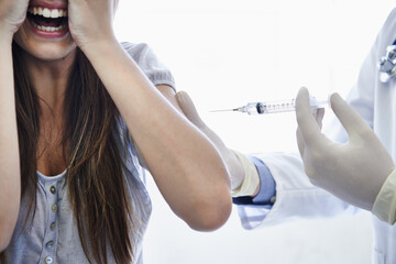 Patient, doctor and syringe injection with fear, scream or needle for flu vaccination,...